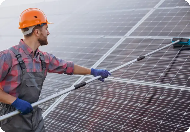 A man cleaning a 10 kW solar system.